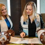 two women read the torah from the pulpit