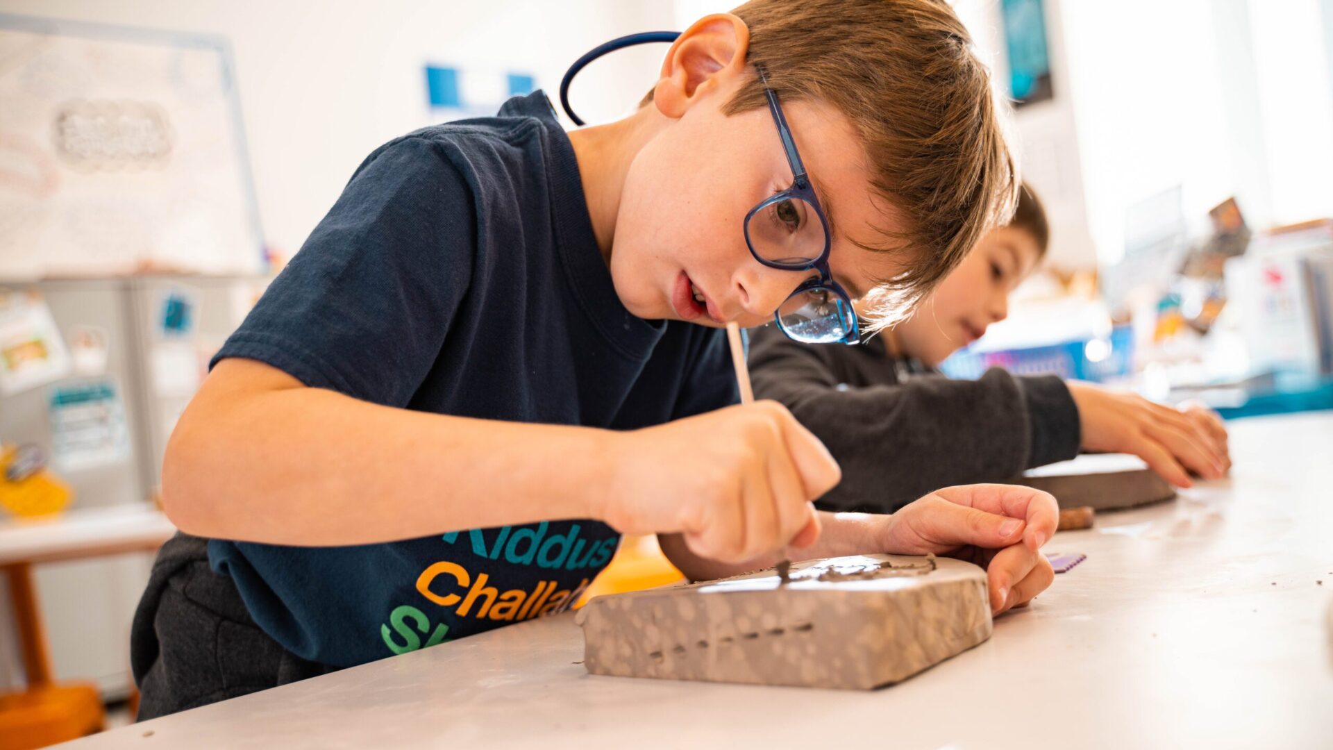 Rambam Day School boy making an art project