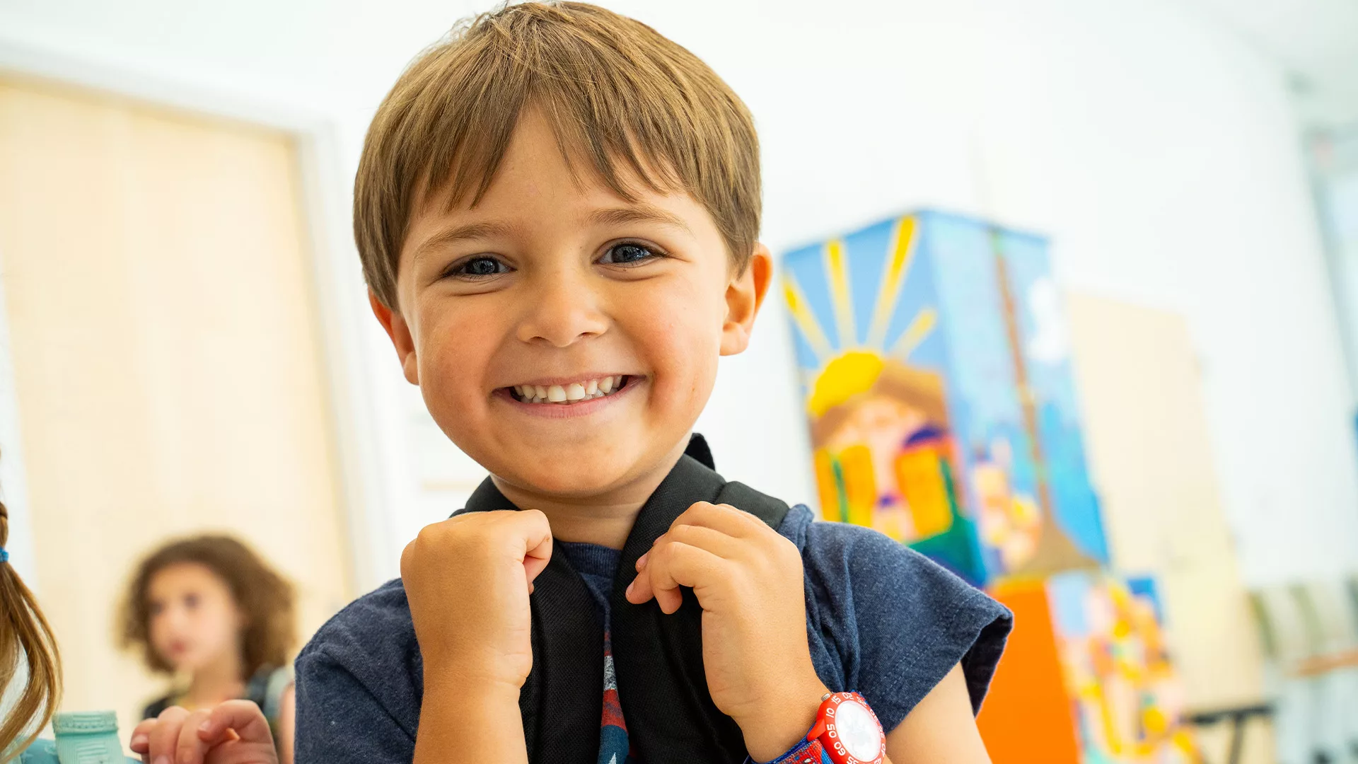 Boy smiling with backpack 