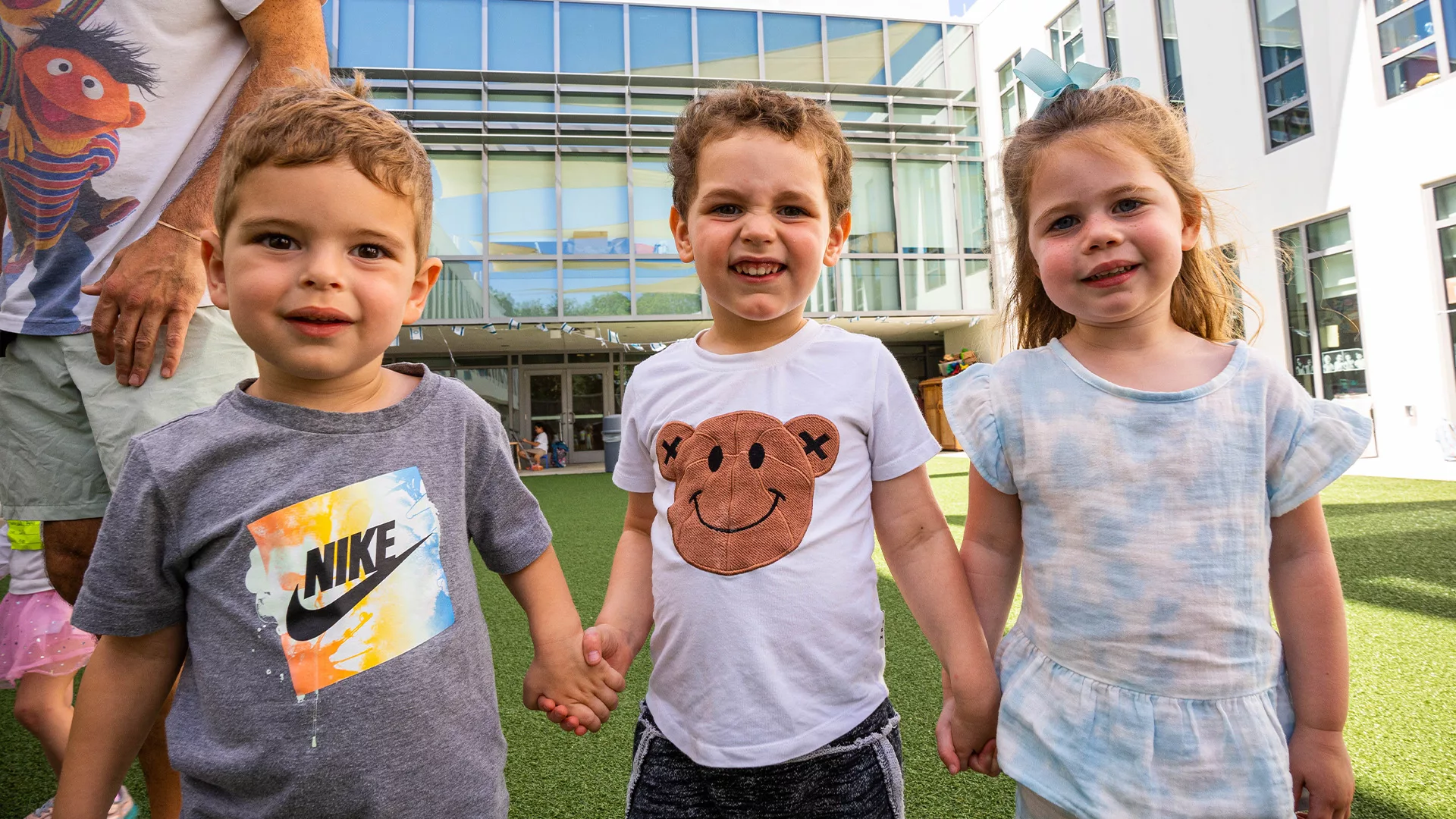 Kids smiling holding hands 