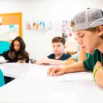 boy reading at table in religious school