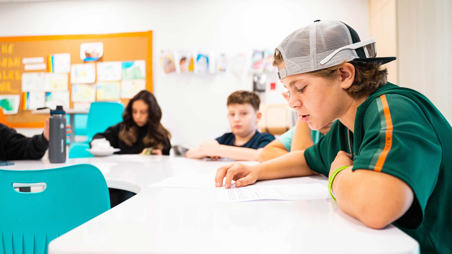 boy reading at table in religious school