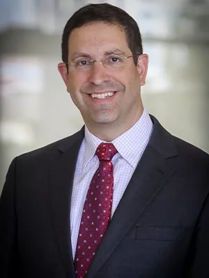 Gil Hoffman Headshot smiling in suit 