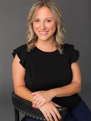 Jacki Alexander headshot in black shirt smiling 