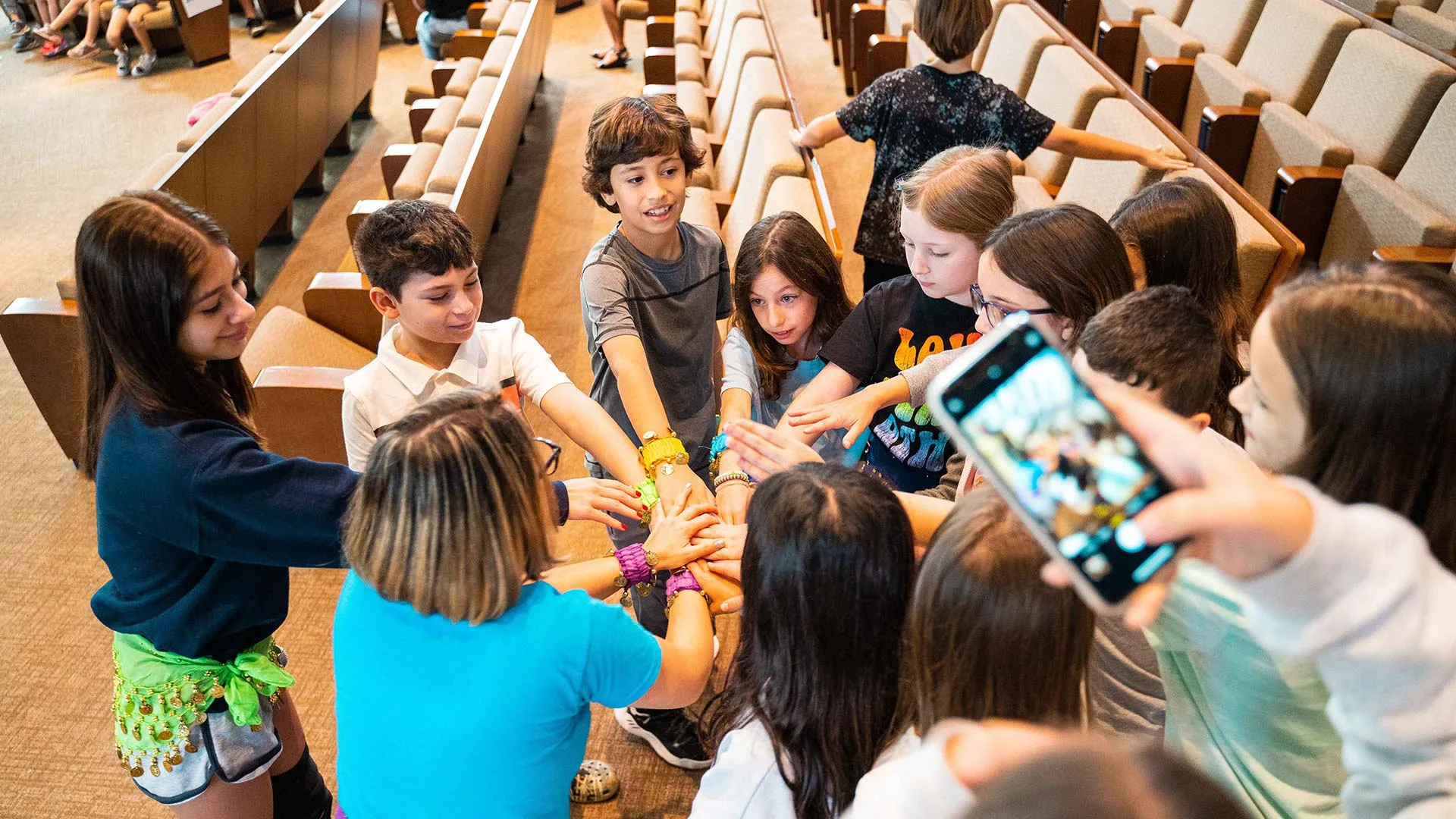 group of students in a collective high five
